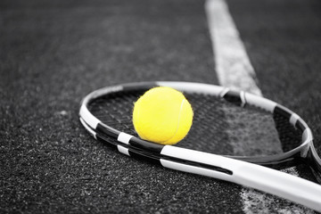Tennis racket and ball on court