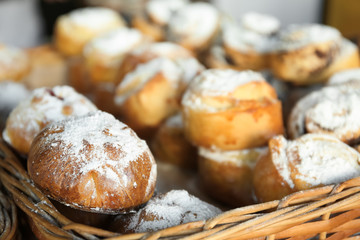 Fresh tasty bakery products in wicker basket