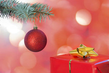 christmas bauble on christmas tree with gift on bokeh background
