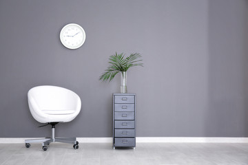 Minimalist interior with swivel chair and drawer unit
