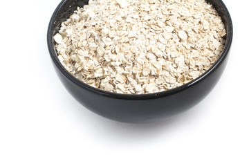 Oats flakes in a black bowl
