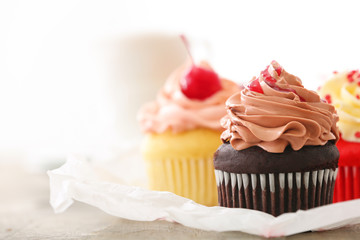 Delicious cupcakes on table