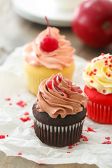 Delicious cupcakes on table