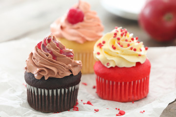 Delicious cupcakes on table