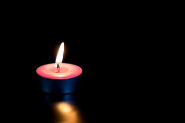 Light from a candle in the dark.