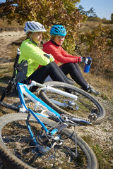 Two female cyclist enjoying the beautiful scenery while out mountain biking.