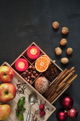 Ingredients for Hot mulled wine with apple, orange, anise and cinnamon with fresh fruits on wooden table. Winter and fall. Christmas and holidays food.
