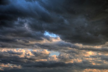 Fototapeta na wymiar dramatic heavy blue clouds stormy windy danger