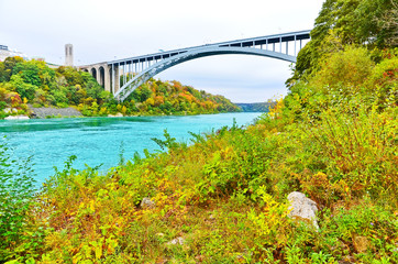 View of Niagara River and Rainbow Bridge at the downstream of Niagara Falls in autumn.
