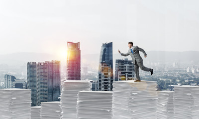 Fototapeta premium Precise businessman in suit running with phone.
