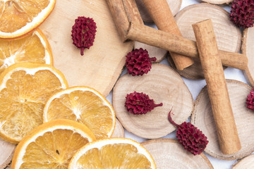 Dried orange slices on a wooden background arranged with cinnamon