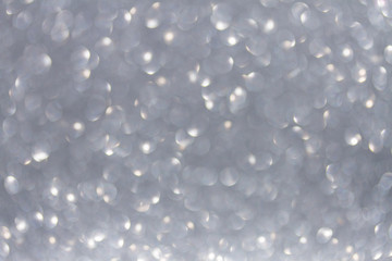 Christmas festives glittering defocused gray background with bokeh lights