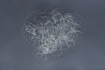 Silver thread pile like cloud. Pile of silver thread on grey background.