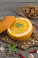 pumpkin puree soup on a wooden table. 