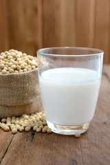 Soy milk and soy bean on wooden background