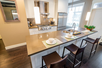 Fototapeta premium Modern, bright, clean, kitchen interior with stainless steel appliances in a luxury house