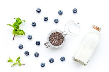 Eat chia seeds for breakfast with yogurt, blueberry and mint. White background top view
