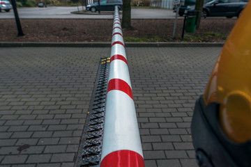 A breakpoint with barrier and tire puncture spike strip - stoping line with big spike to stop car. Tire spikes being used at the exit to a park or hotel or security areas