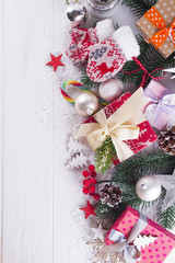 Christmas background with gift boxs, christmas tree, mittens and decorations
