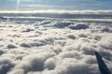 Fototapeta premium Over the clouds. Photo from plane.