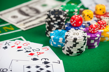 Poker chips on table in casino. Cards on green felt casino table