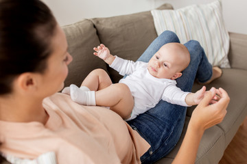 happy mother with little baby boy at home