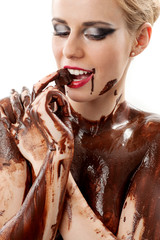 amazing blonde female model covered in chocolate tasting a Belgiane chocolate praline with great...