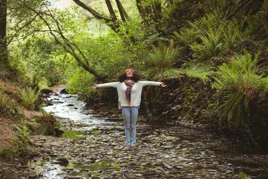 Full Length Of Woman With Arms Outstretched At Forest