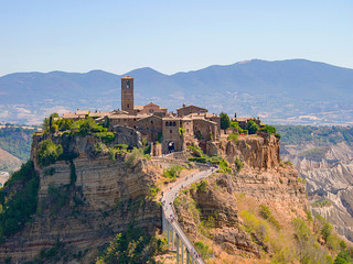 Fototapeta premium view of the beautiful Civita di Bagnoregio, Italy, with the famous bridge below and the mountains in the background