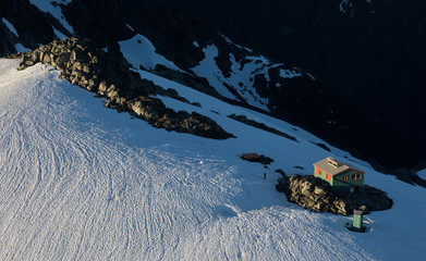 A cabin perched on the top of a mountain 