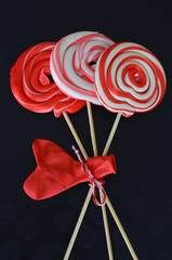 Valentines day lollipops on a black background