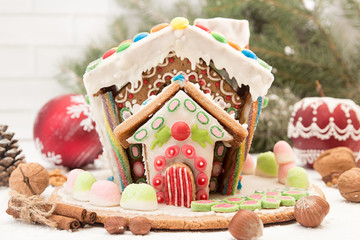 Gingerbread house. Christmas holiday sweets. European Christmas holiday traditions. Christmas gingerbread house and holiday decorations.