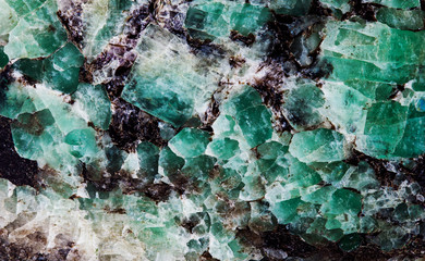 Malachite in mica group of sheet silicate minerals. Natural decorative stone texture pattern macro view.