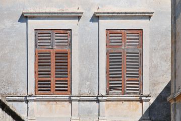 Old windows with wooden shutters from the sun