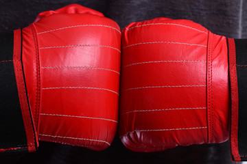 Boxer presses hands together. Athletes hands in leather gloves