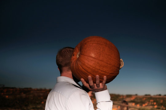 The man carrying a pimpkin