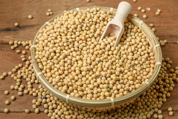 Soy beans with wooden spoon in bamboo basket