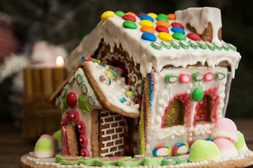 Gingerbread house. Christmas holiday sweets. European Christmas holiday traditions. Christmas gingerbread house and holiday decorations.