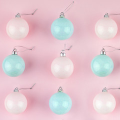 Pink and blue Christmas baubles decoration on bright pink background. Flat lay. Holiday concept. Minimal idea