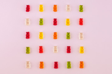 Pattern made of jelly bears on pink background. Flat lay. Minimal concept