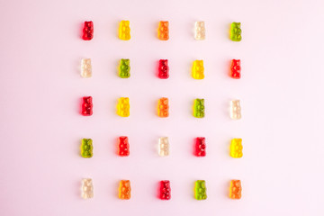 Pattern made of jelly bears on pink background. Flat lay. Minimal concept