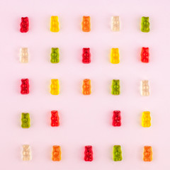 Pattern made of jelly bears on pink background. Flat lay. Minimal concept