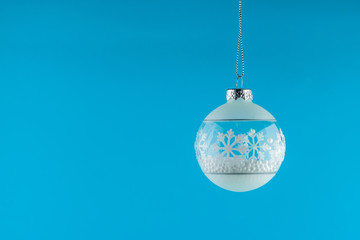 White christmas ball ornament on blue background. minimal concept idea