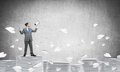 Businessman standing with megaphone.