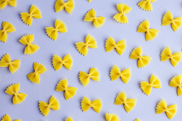 Pattern made of pasta on violet background. Flat lay. Minimal concept