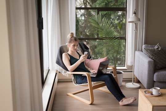Woman using mobile phone and smartphone at home