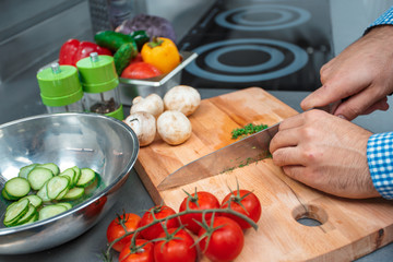 The chef in brown apron cooking in a restaurant kitchen