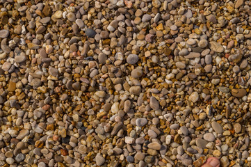 Small pebbles and sand as a background, texture