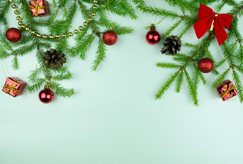  Christmas tree branches with  cones, red balls and small presents, copy space