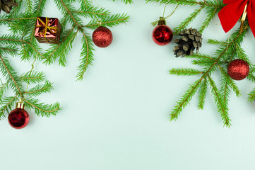  Christmas tree branches with  cones, red balls and small presents, copy space